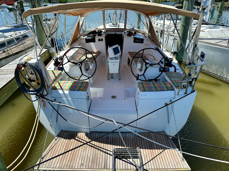 Slide: The Image of 2018 Jeanneau Sun Odyssey 419 sailboat with dual steering wheels, docked at a marina. - 8