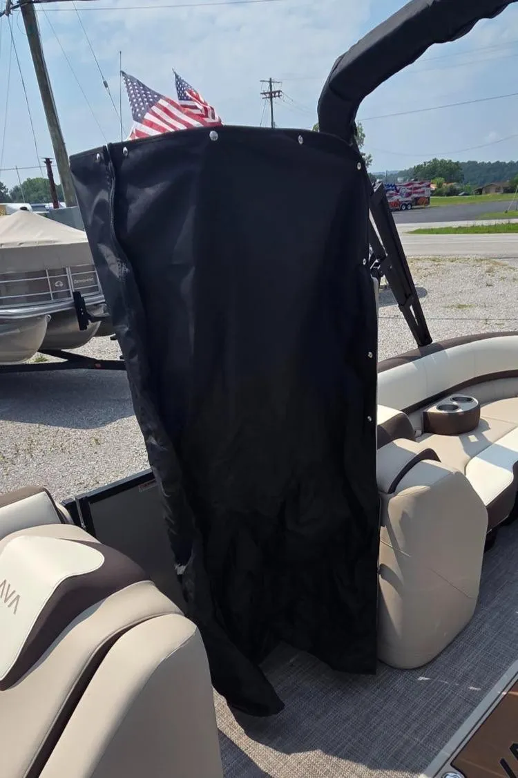 Slide: The Image of 2025 Avalon Platinum Catalina 2385 Elite boat interior with black privacy curtain and American flags. - 17