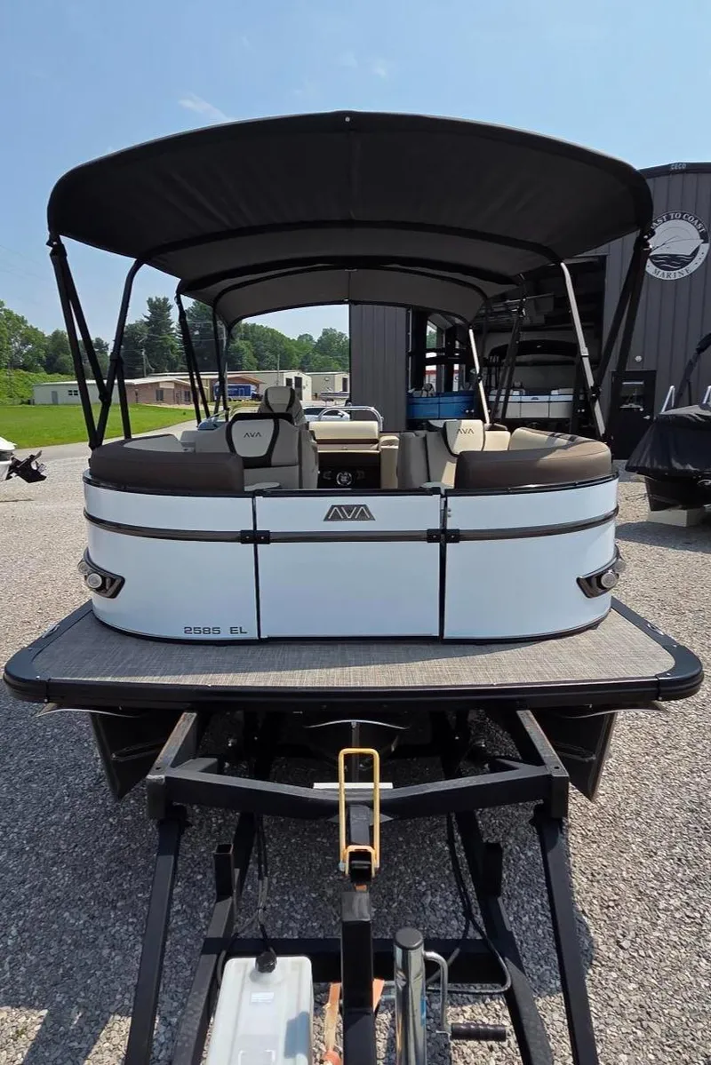 Slide: The Image of 2025 Avalon Platinum Catalina 2385 Elite pontoon boat on trailer, outdoor setting. - 3