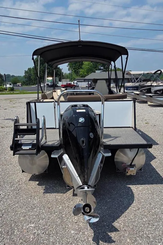 Slide: The Image of 2025 Avalon Platinum Catalina 2385 Elite pontoon boat, rear view, parked outdoors. - 4