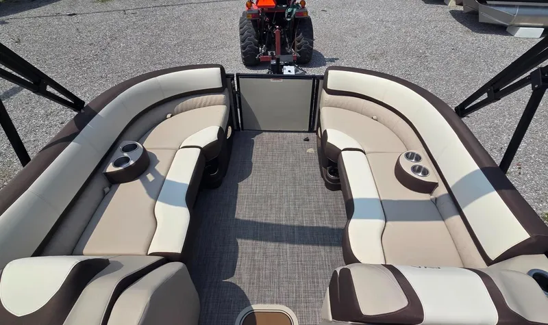 Slide: The Image of 2025 Avalon Platinum Catalina 2385 Elite boat interior with beige seating and cup holders. - 5