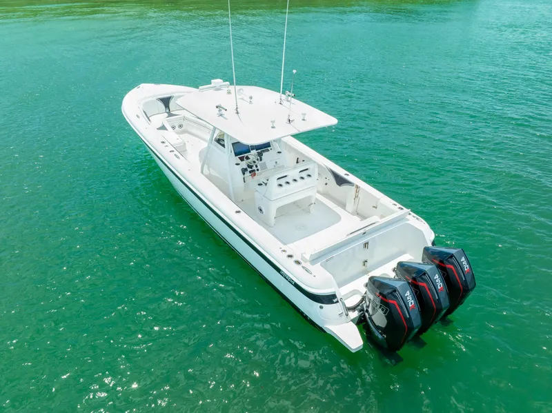 Slide: The Image of 2018 Intrepid 375 Open boat with triple outboard engines on clear turquoise water. - 11