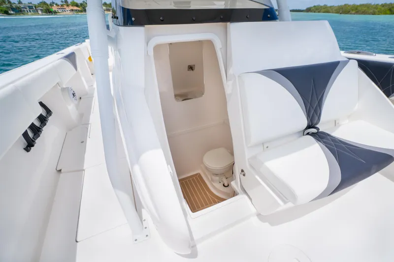 Slide: The Image of 2018 Intrepid 375 Open boat interior with seating and compact toilet area. - 28