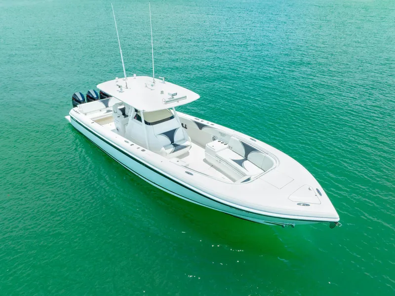 Slide: The Image of 2018 Intrepid 375 Open boat on clear turquoise water, showcasing sleek design and triple engines. - 8