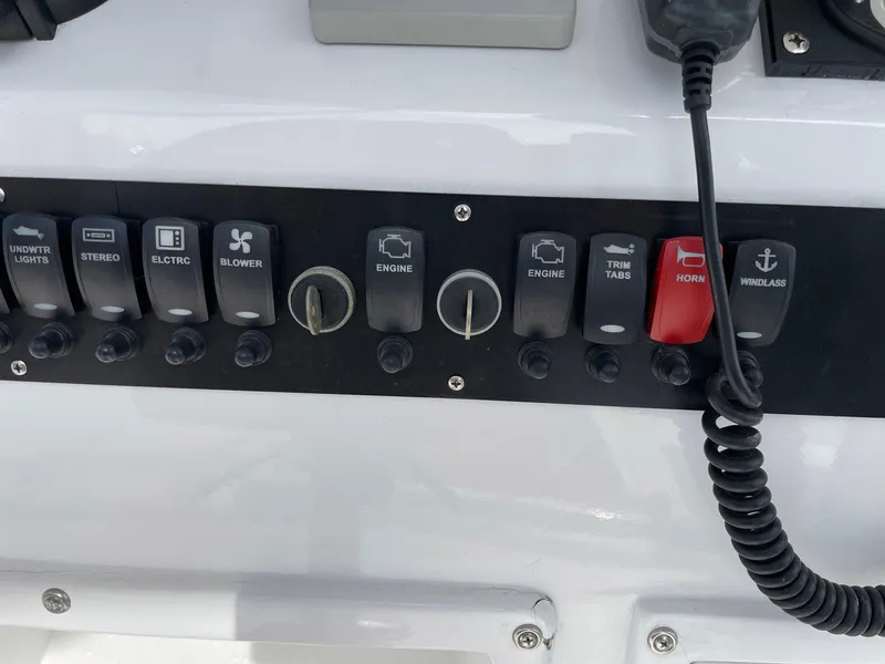 Slide: The Image of Control panel of a 1986 Egg Harbor 41 Convertible boat with various switches and knobs. - 23