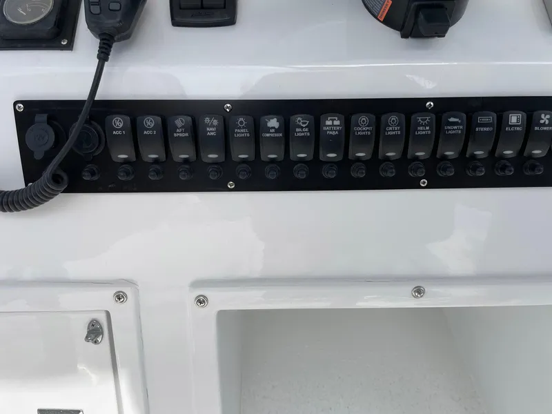 Slide: The Image of Control panel of a 1986 Egg Harbor 41 Convertible boat with labeled switches. - 24