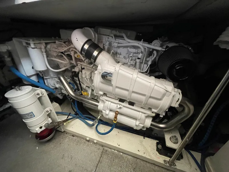 Slide: The Image of Engine room of 1986 Egg Harbor 41 Convertible boat, showcasing mechanical components and piping. - 27