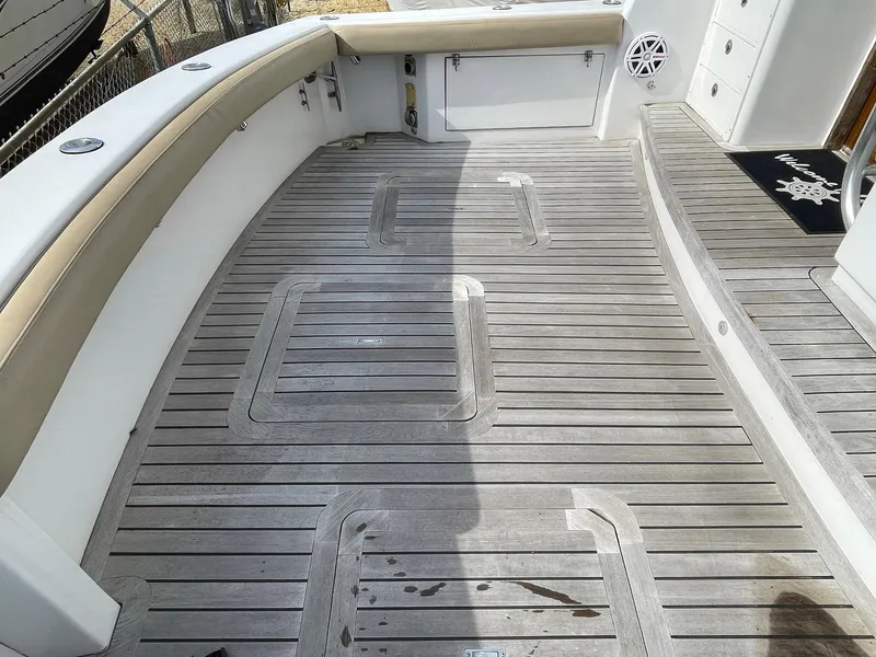 Slide: The Image of 1986 Egg Harbor 41 Convertible boat deck with teak flooring and cushioned seating. - 32