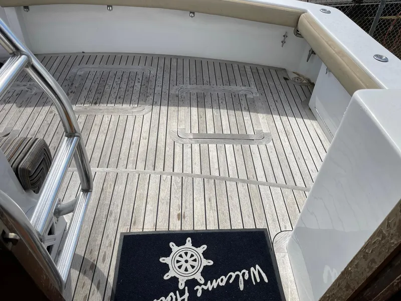 Slide: The Image of 1986 Egg Harbor 41 Convertible boat deck with wooden flooring and welcome mat. - 33