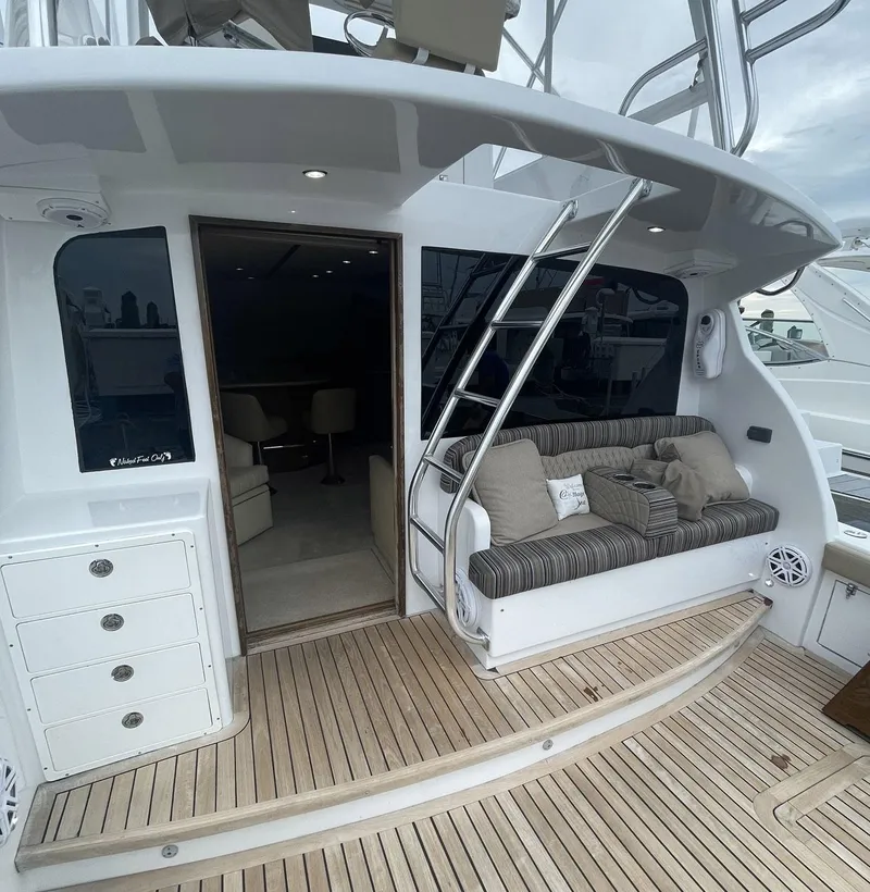 Slide: The Image of 1986 Egg Harbor 41 Convertible yacht with teak deck, cushioned seating, and ladder access. - 35