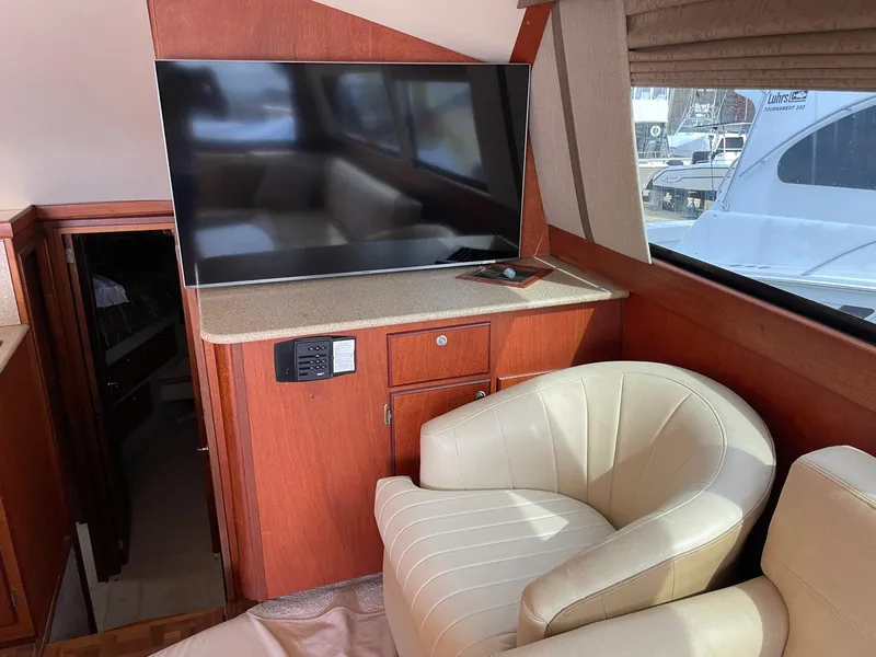 Slide: The Image of Interior of 1986 Egg Harbor 41 Convertible yacht with TV and cream chair. - 5