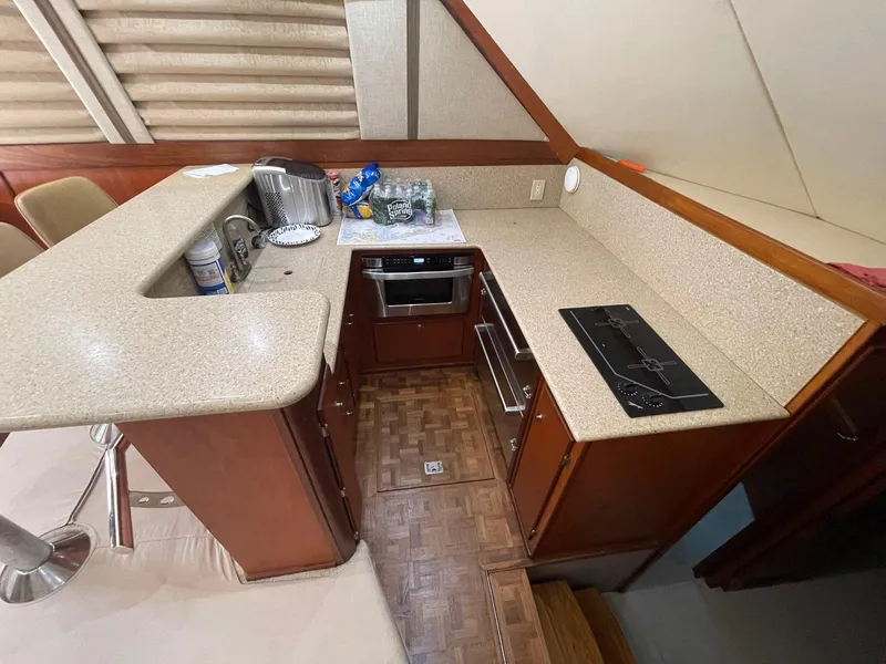 Slide: The Image of 1986 Egg Harbor 41 Convertible yacht kitchen with modern appliances and wooden cabinetry. - 7