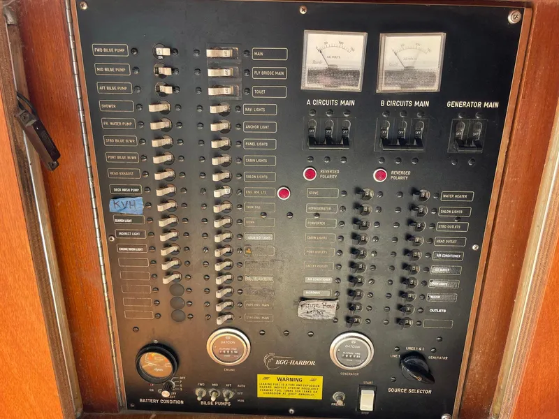 Slide: The Image of Electrical panel of a 1986 Egg Harbor 41 Convertible boat with switches and gauges. - 9