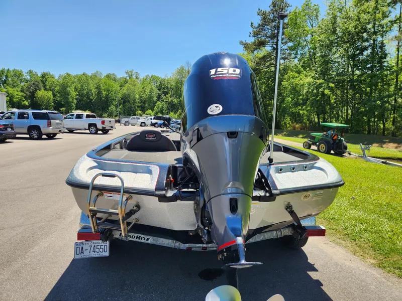 Slide: The Image of 2017 Ranger Z518 boat with 150 HP motor, parked outdoors on a sunny day. - 3
