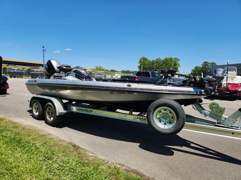 Slide: The Image of 2017 Ranger Z518 boat on trailer in parking lot under clear blue sky. - 6