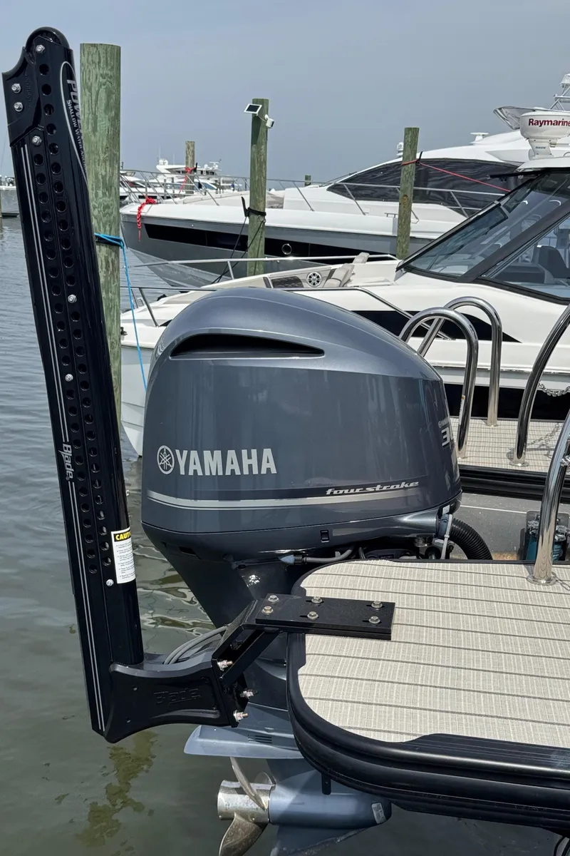 Slide: The Image of 2021 Barletta L25UE pontoon boat with Yamaha outboard motor docked at marina. - 15