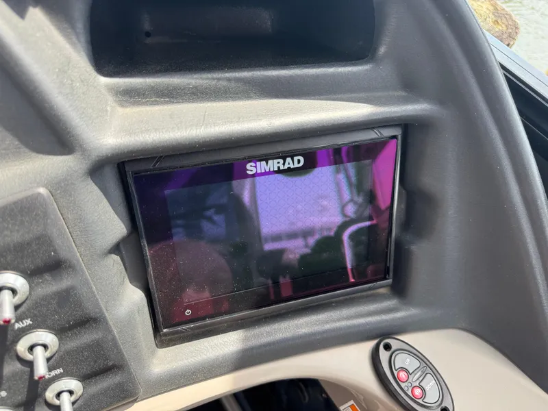 Slide: The Image of Simrad display on 2021 Barletta L25UE boat dashboard with control buttons. - 18