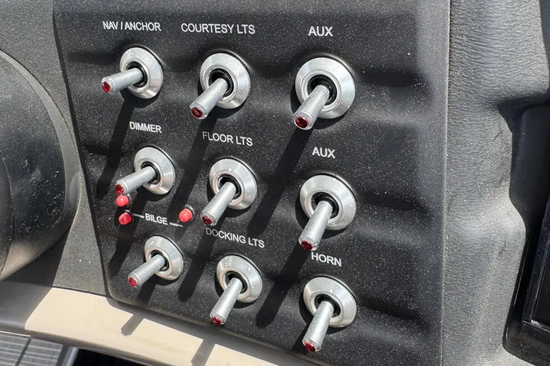 Slide: The Image of Control panel of a 2021 Barletta L25UE boat with various toggle switches. - 23