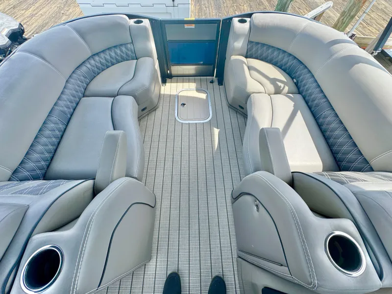 Slide: The Image of 2021 Barletta L25UE boat interior with luxurious seating and cup holders. - 4