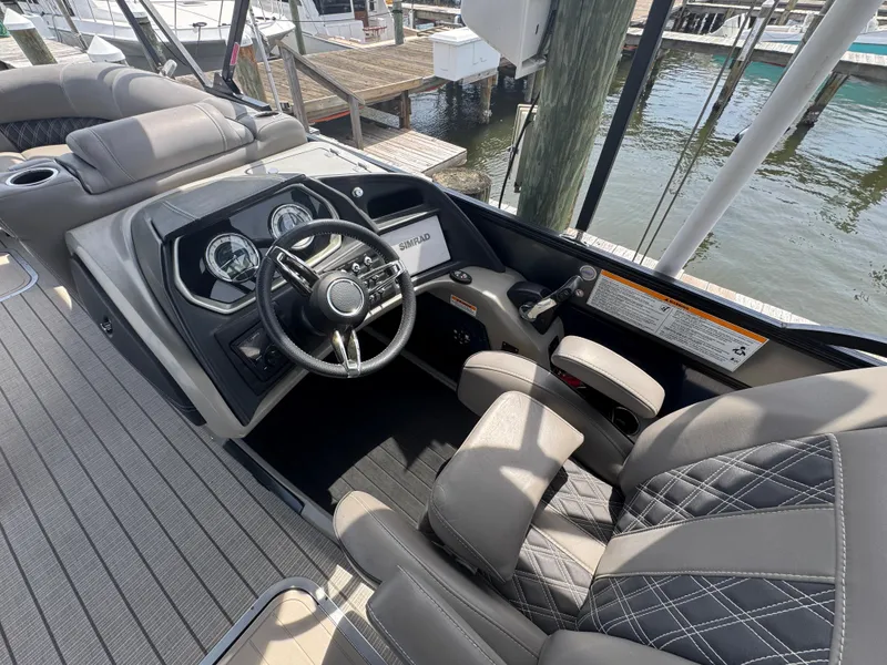 Slide: The Image of 2021 Barletta L25UE boat cockpit with steering wheel and luxurious seating. - 8