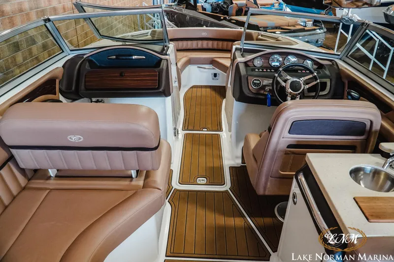 Slide: The Image of 2013 Cobalt A28 boat interior with luxurious seating and modern dashboard at Lake Norman Marina. - 10