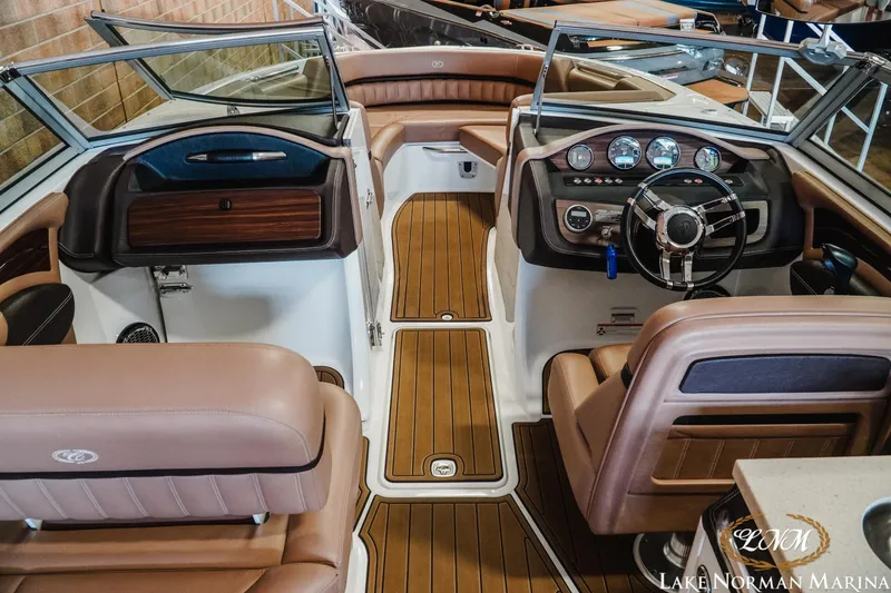 Slide: The Image of Interior of a 2013 Cobalt A28 boat with luxurious seating and modern dashboard. - 12