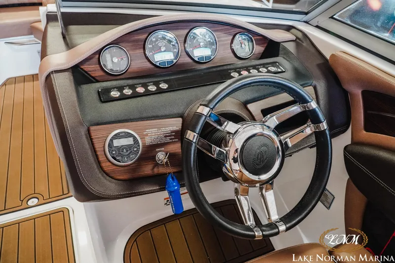 Slide: The Image of Dashboard of a 2013 Cobalt A28 boat with steering wheel and gauges. - 15