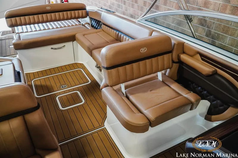 Slide: The Image of Luxurious interior of 2013 Cobalt A28 boat with brown leather seating and wood flooring. - 21