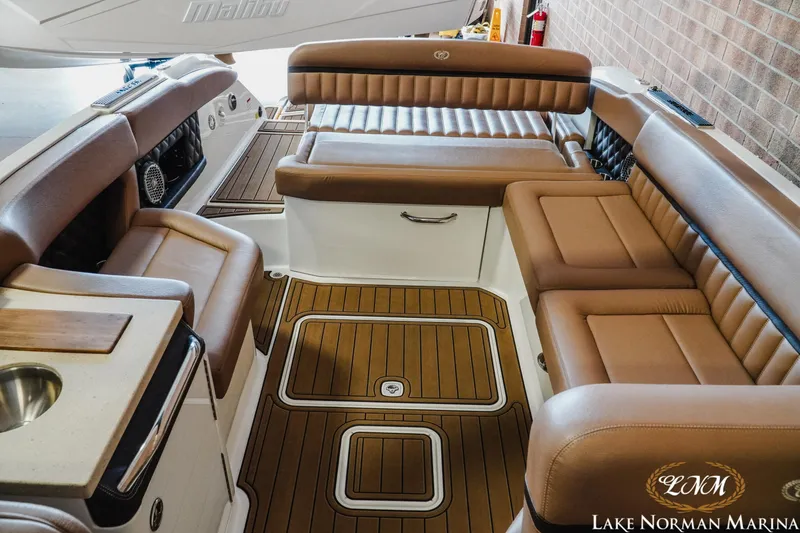 Slide: The Image of Luxurious interior of 2013 Cobalt A28 boat with tan leather seating and wood flooring. - 23
