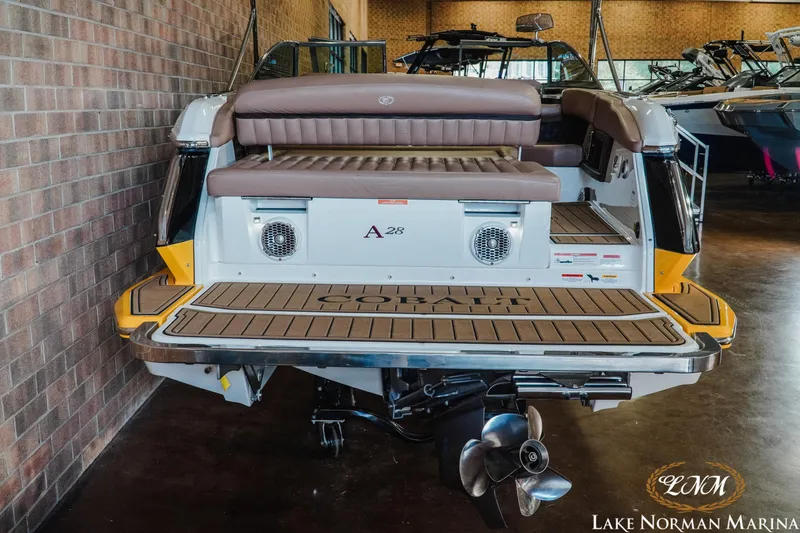 Slide: The Image of 2013 Cobalt A28 boat at Lake Norman Marina, showcasing rear seating and propeller. - 7