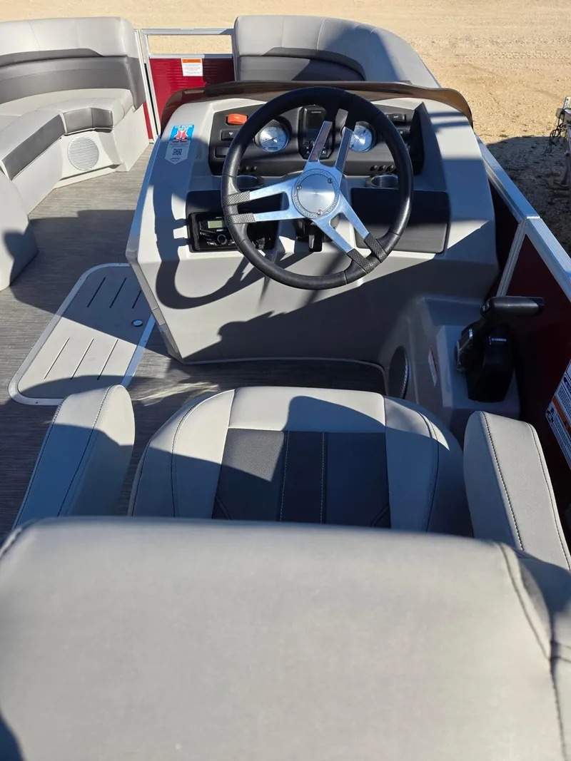 Slide: The Image of 2023 Bennington 22SXSRC boat interior with steering wheel and seating. - 10