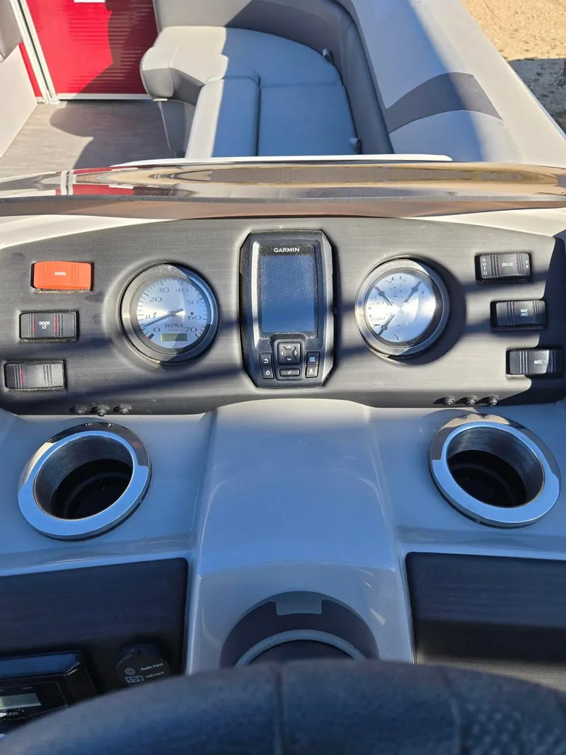 Slide: The Image of Dashboard of 2023 Bennington 22SXSRC boat with gauges and cup holders. - 12