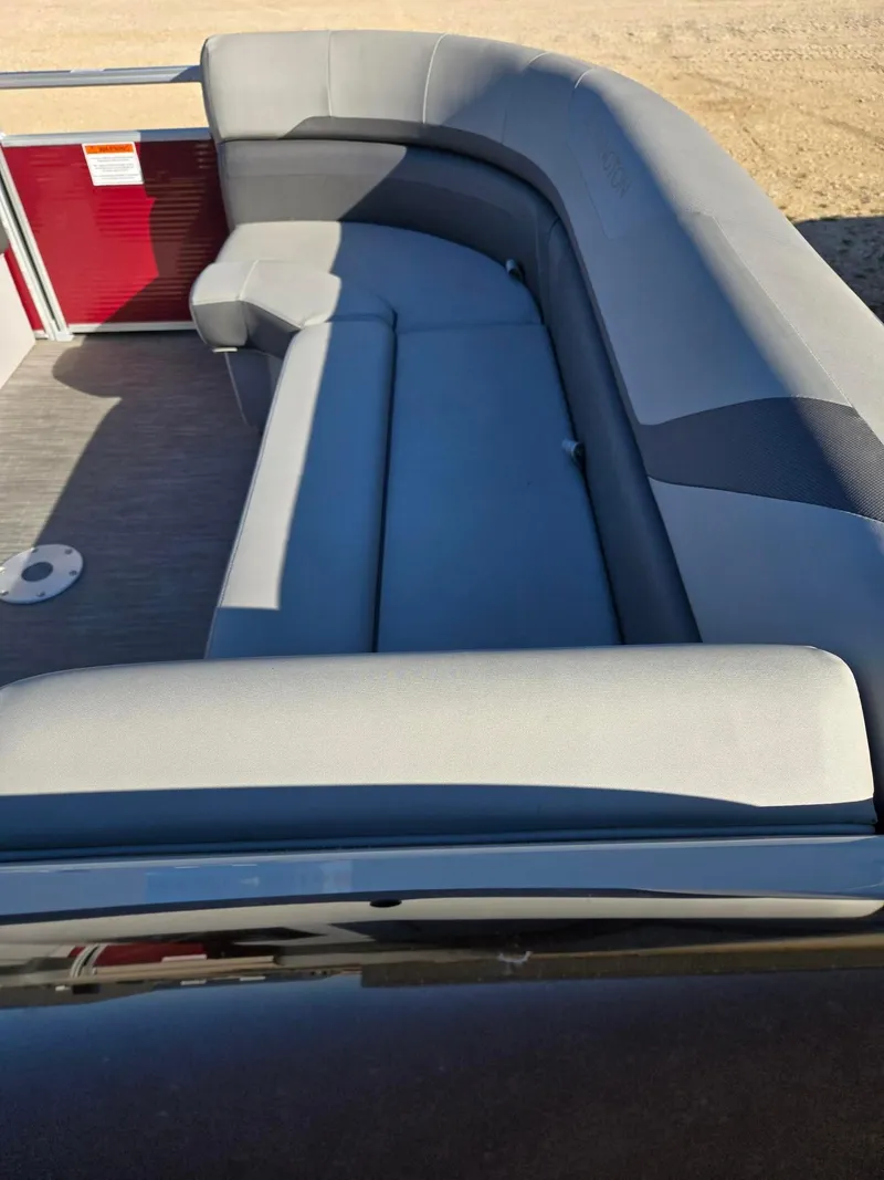 Slide: The Image of 2023 Bennington 22SXSRC boat interior with gray seating and red panel. - 14