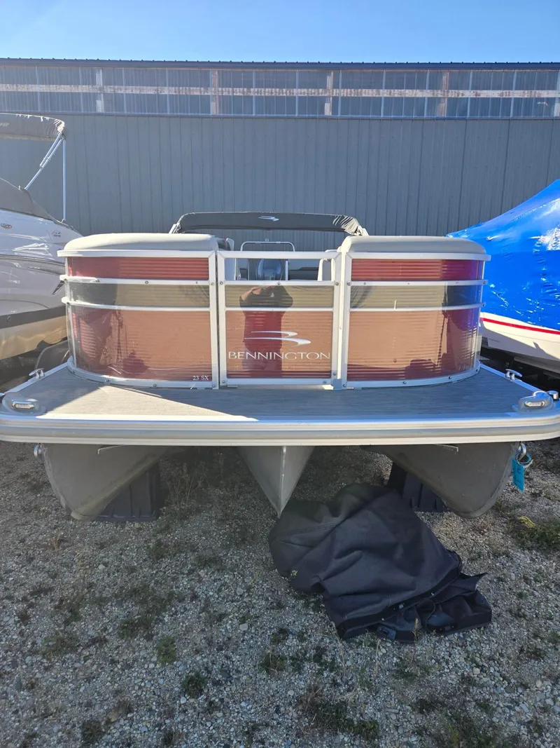 Slide: The Image of 2023 Bennington 22SXSRC pontoon boat in storage, front view. - 5
