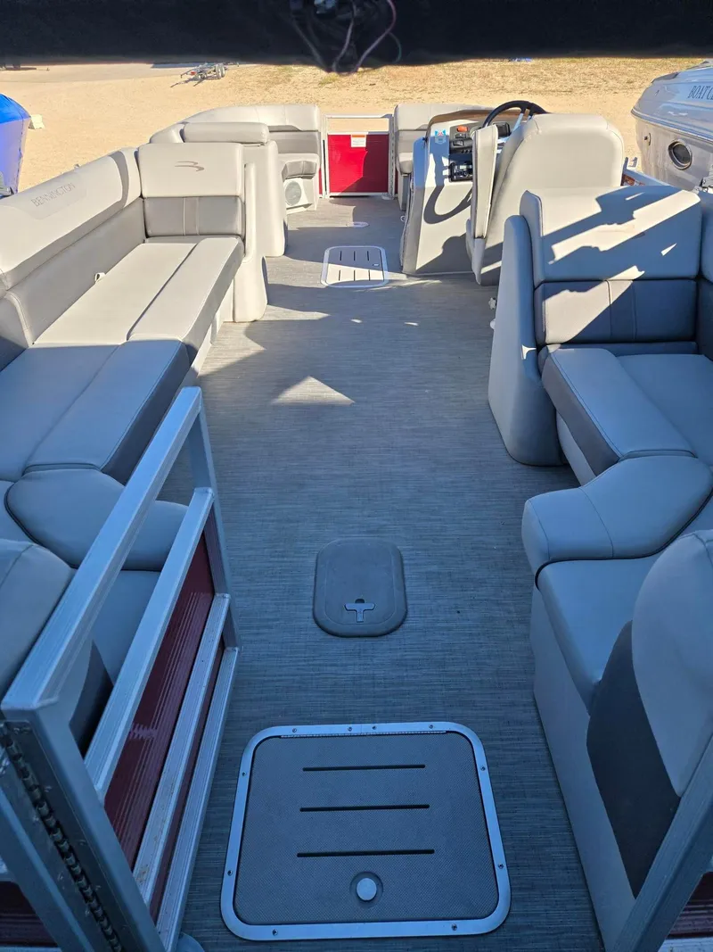 Slide: The Image of 2023 Bennington 22SXSRC pontoon boat interior with gray seating and steering console. - 6