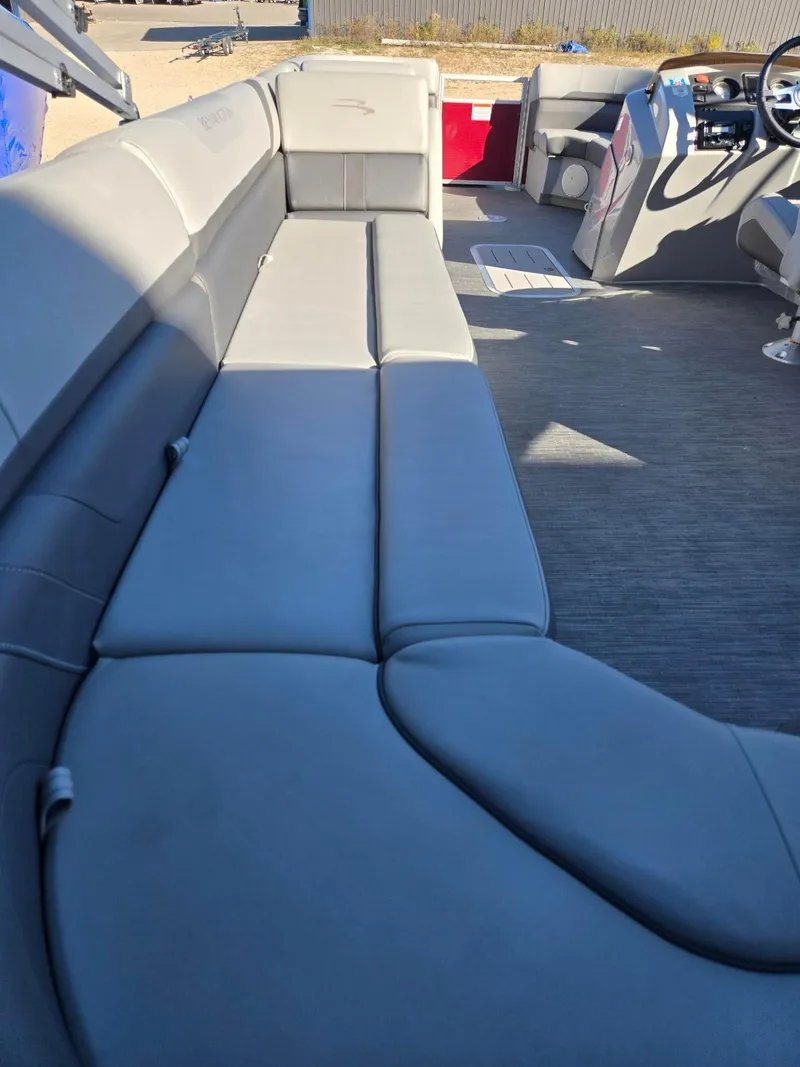 Slide: The Image of 2023 Bennington 22SXSRC pontoon boat interior with gray seating and steering console. - 7