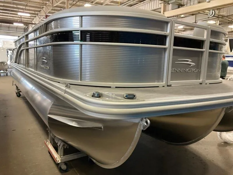 Slide: The Image of 2022 Bennington 23SXSR pontoon boat in a warehouse setting. - 1