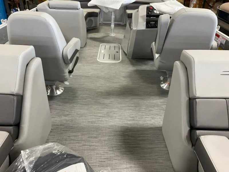Slide: The Image of 2022 Bennington 23SXSR boat interior with gray seating and flooring, showcasing modern design. - 3