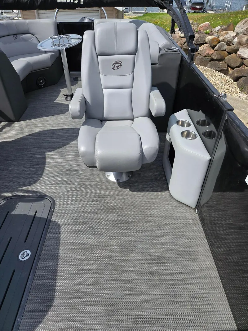 Slide: The Image of 2021 Lowe Retreat 230 High Performance boat interior with gray seating and cup holders. - 11