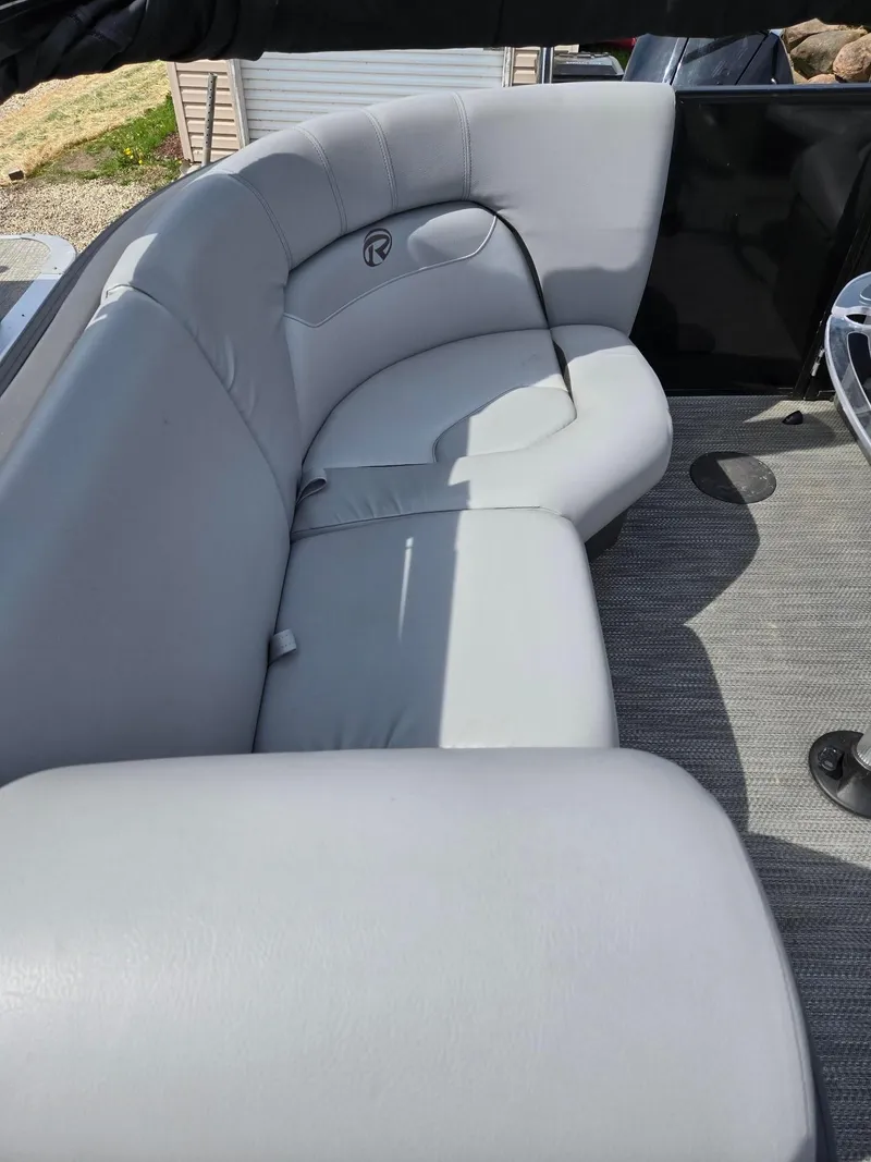 Slide: The Image of Gray seating on 2021 Lowe Retreat 230 High Performance boat, featuring plush upholstery. - 13