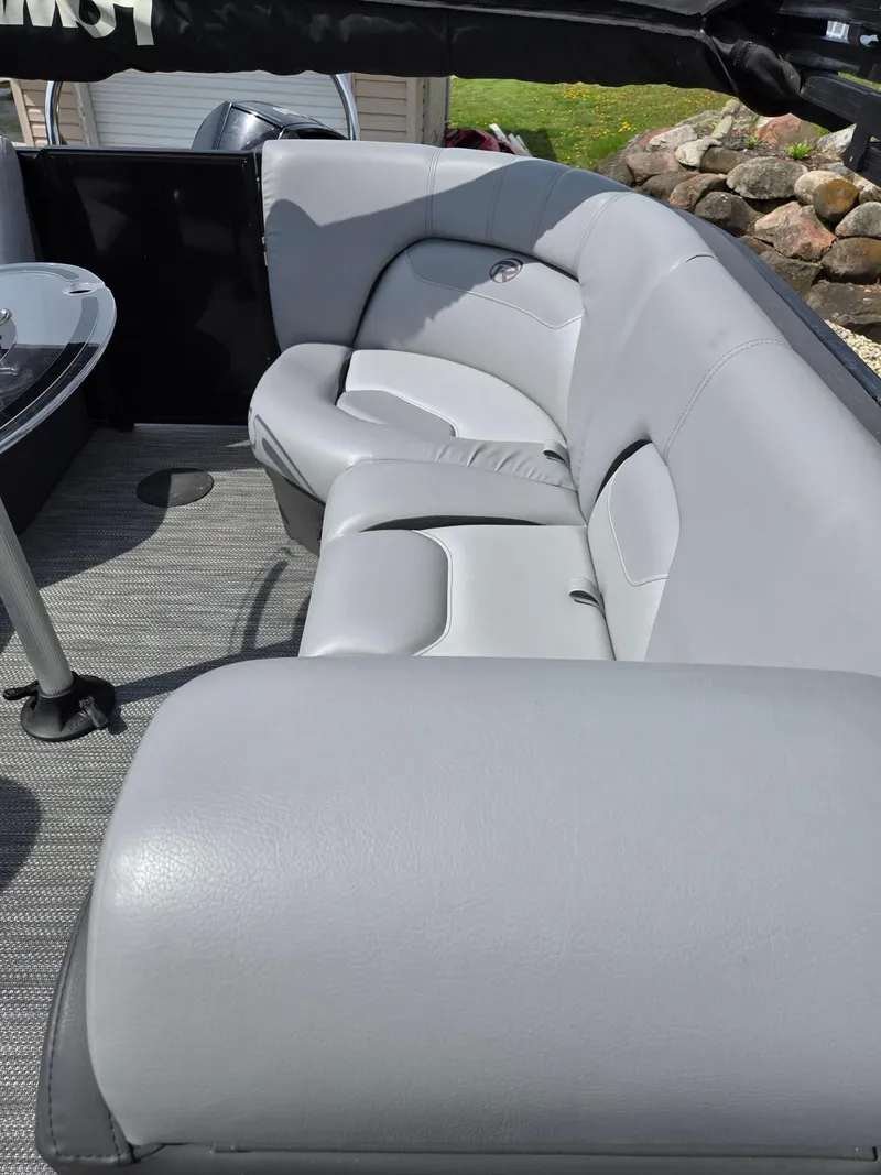 Slide: The Image of 2021 Lowe Retreat 230 High Performance boat with gray leather seating. - 14