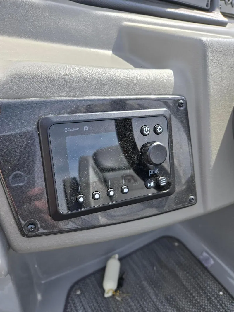Slide: The Image of Control panel of a 2021 Lowe Retreat 230 High Performance boat with Polk audio system. - 20