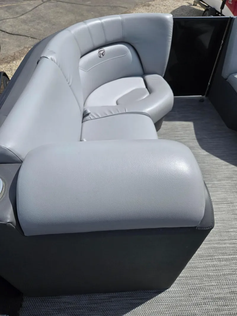 Slide: The Image of 2021 Lowe Retreat 230 High Performance boat with gray cushioned seating. - 21