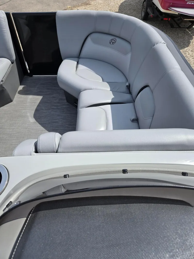 Slide: The Image of 2021 Lowe Retreat 230 High Performance boat with gray seating and spacious interior. - 22