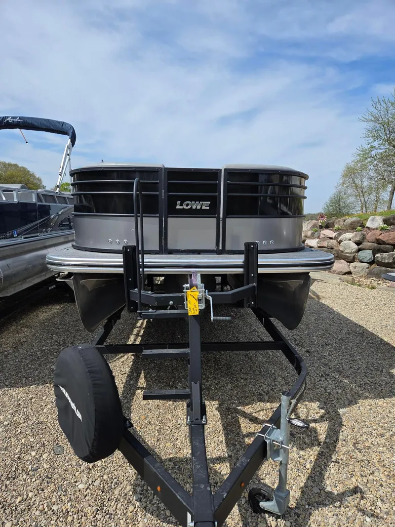 Slide: The Image of 2021 Lowe Retreat 230 High Performance pontoon boat on trailer, parked outdoors. - 3