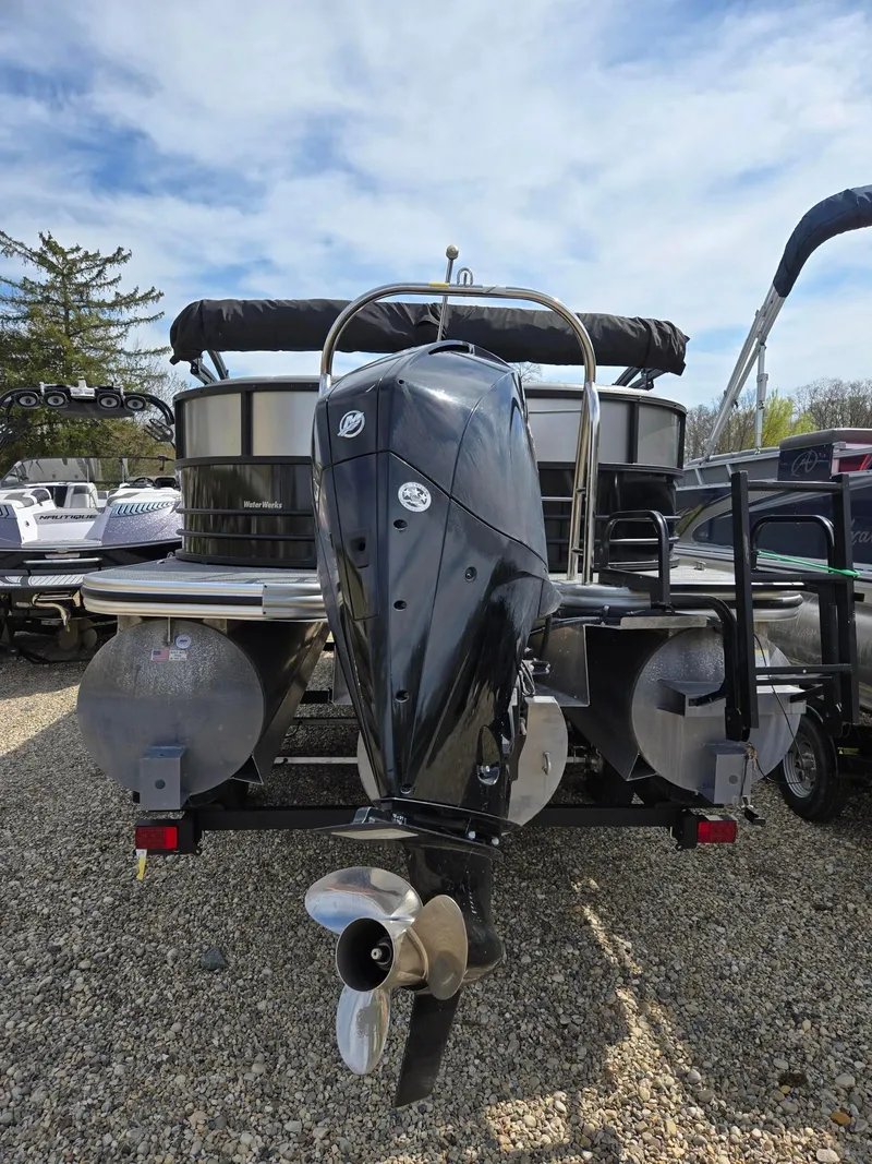 Slide: The Image of 2021 Lowe Retreat 230 High Performance boat with powerful outboard motor, parked on gravel. - 6
