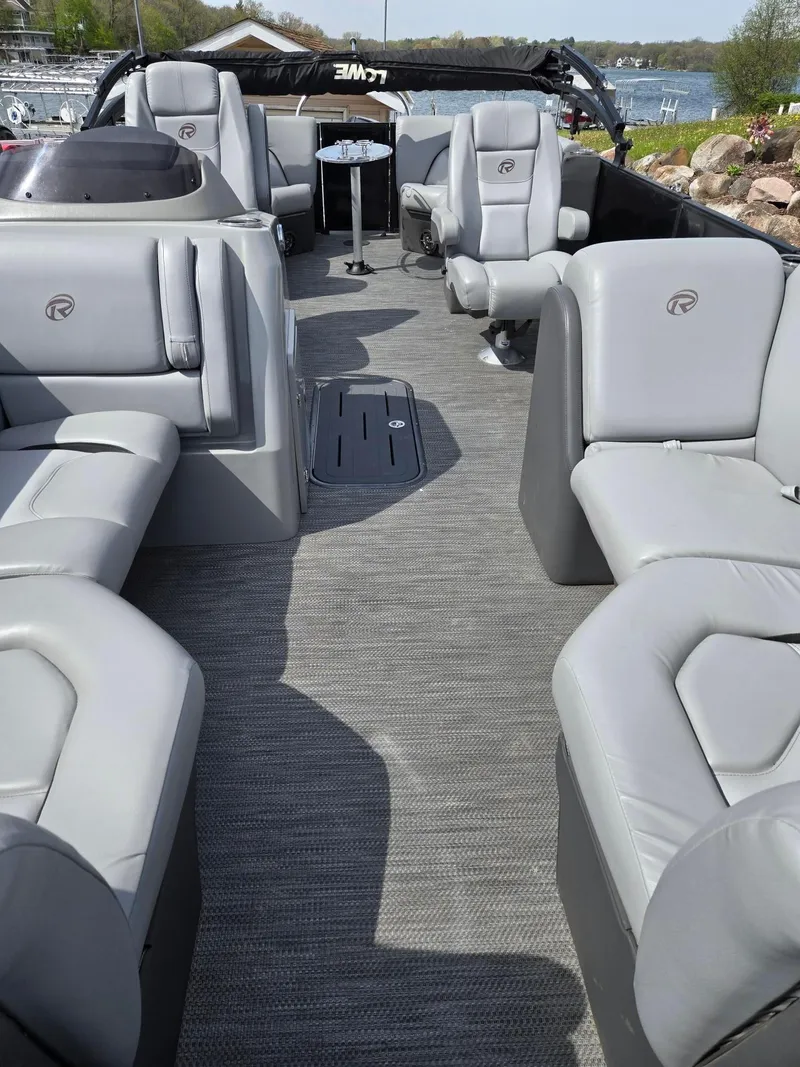Slide: The Image of 2021 Lowe Retreat 230 High Performance boat interior with gray seating and carpet. - 7