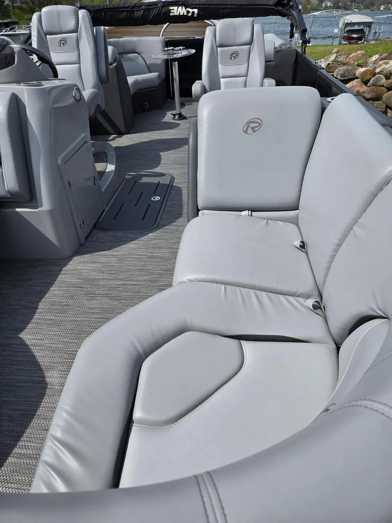 Slide: The Image of 2021 Lowe Retreat 230 High Performance boat with luxurious gray seating and spacious interior. - 9