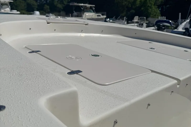 Slide: The Image of 2014 Carolina Skiff 218 DLV boat deck with storage compartments. - 6