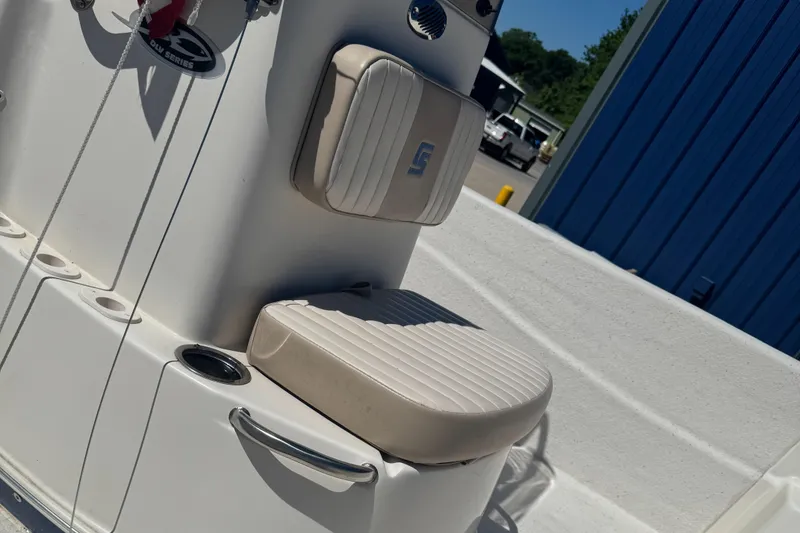 Slide: The Image of 2014 Carolina Skiff 218 DLV boat interior with cushioned seating and rod holders. - 8